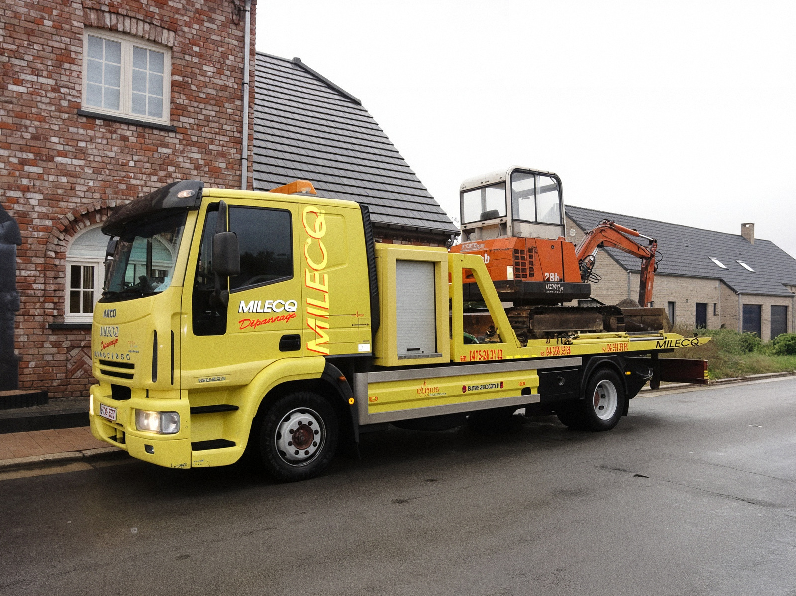 Mini-pelle de chantier sur le plateau du camion Milecq, direction chantier